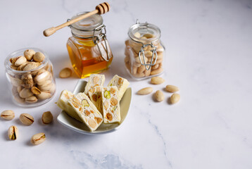 White chocolate covered nougat. Nougat with pistachios and almonds. These delicious confections are...