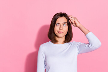 Photo of unsure thoughtful young woman wear white sweater finger head forget important thing...