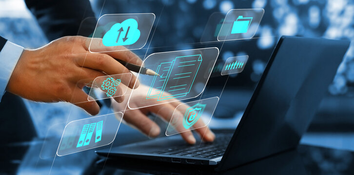 Businesman using a laptop with digital graph to document management. Software online documentation database and digital file storage system and file access concept.Enterprise resource planning.