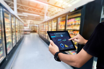 Fototapeta na wymiar Smart retail management system.Worker hands holding tablet on blurred supermartket as background