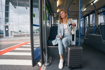 Passenger seated in transport vehicle staring into distance