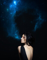 Obraz na płótnie Canvas Brunette woman Smoking cosmos galaxy on dark star background in black dress. Art Fashion girl
