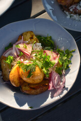 Tasty potato wedges. Fast food take away. Fried potatoes at rustic wooden boards background. Potatoes at stone.