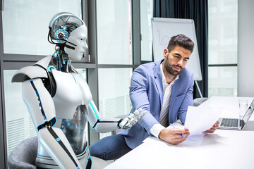 A humanoid robot and a businessman work together. - obrazy, fototapety, plakaty