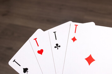 Four aces close up on wooden background
