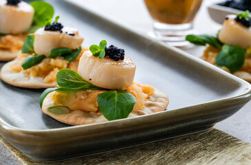 Canapes with scallops, caviar and lime and butter sauce