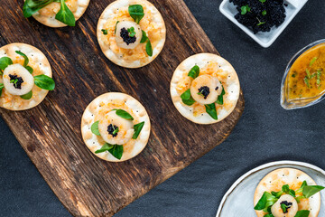 Canapes with scallops, caviar and lime and butter sauce