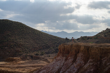 Adventurous young girl taking pictures in the mountains of the Mazarron desert