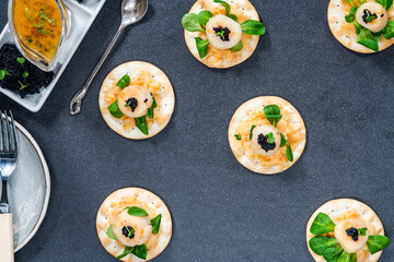 Canapes with scallops, caviar and lime and butter sauce