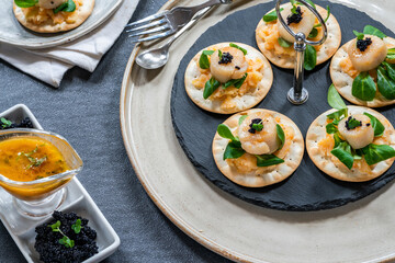 Canapes with scallops, caviar and lime and butter sauce