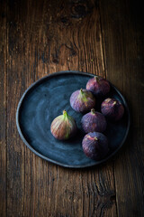 Organic figs over white rustic wooden background