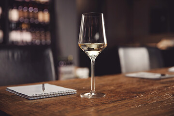 Glass of white wine for tasting in restaurant, social event for meeting friends