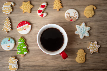 Merry Christmas with homemade cookies and coffee cup on wood table background. Xmas eve, party, holiday and happy New Year concept