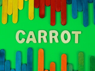 carrot wording wooden ice cream stick with green background