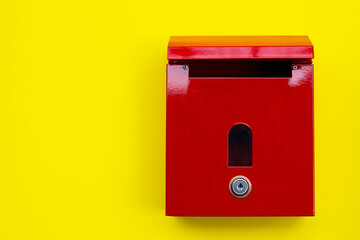 Red mailbox on yellow background.