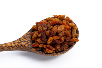 Dried grape raisins in wooden spoon on white background