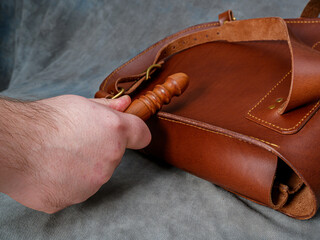 the process of processing the sides of the leather backpack