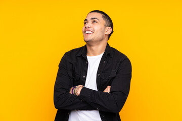 Asian handsome man isolated on yellow background showing thumb down with negative expression