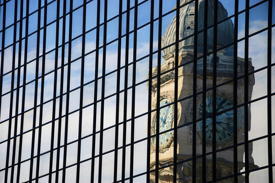 Reflection of clocktower of Gare de Lyon railway station in Paris in the skyscraper glass wall. Paris, France. Travel background.