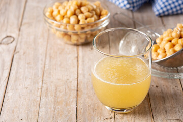 Chickpea water aquafaba on wooden table. Chickpea water is a substitute for eggs in pastries
