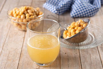 Chickpea water aquafaba on wooden table. Chickpea water is a substitute for eggs in pastries