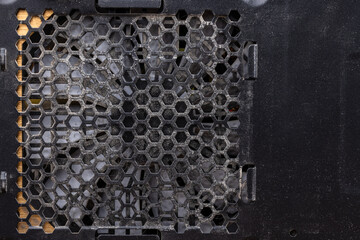 dust covered power supply grid of black desktop pc case