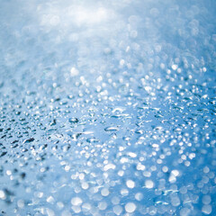 Closeup blue rain water drops shallow depth of field