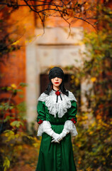 Woman in vintage costume in autumn forest