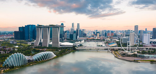 View from above, stunning aerial view of the Singapore skyline with the financial district in the distance during a beautiful sunset. Singapore.