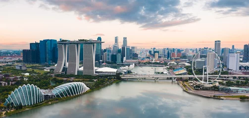 Selbstklebende Fototapeten View from above, stunning aerial view of the Singapore skyline with the financial district in the distance during a beautiful sunset. Singapore. © Travel Wild