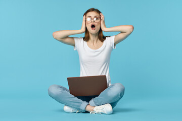 woman with laptop sitting on the floor learning student technology