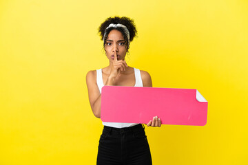 Young african american woman isolated on yellow background holding an empty placard doing silence...
