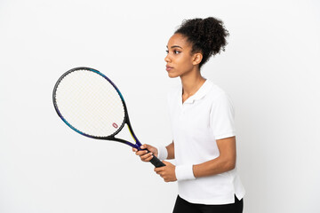 Young latin woman isolated on white background playing tennis