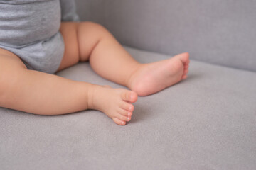 Taking photo of parents practicing babysitting by putting child in corner on soft futon.