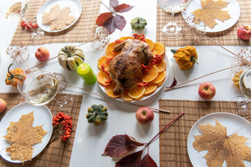 Thanksgiving celebration traditional dinner setting food concept. Top view on roasted turkey on a decorated table.