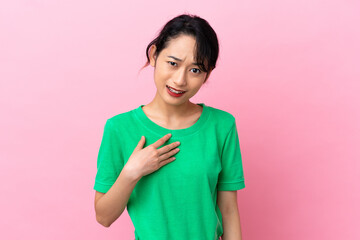 Young Vietnamese woman isolated on pink background pointing to oneself
