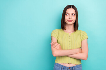 Photo of self-assured lady folded arms look empty space wear green blouse isolated teal color background