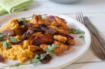 High protein meal with pan fried turkey breast, mashed sweet potatoes and glazed red onions on a plate