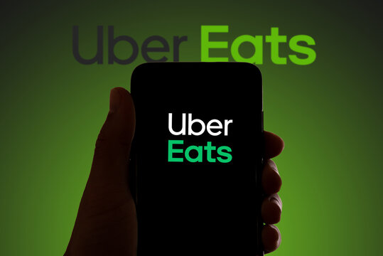 In this photo illustration the logo of the food delivery service Uber Eats is seen on the screen of mobile phone and of a laptop in Barcelona, Spain on November 4, 2021.