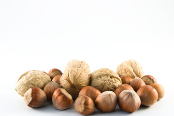 Group of hazelnuts and walnuts in a shell isolated with copy space