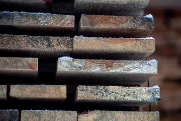 freshly sawn boards lie in a warehouse near the railway tracks