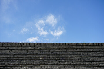 City wall, brick wall, blue sky and white clouds