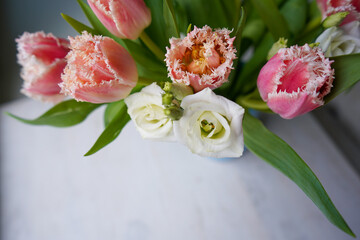 Top view of pink tulips bouquet with pink ribbon. International Women's Day.