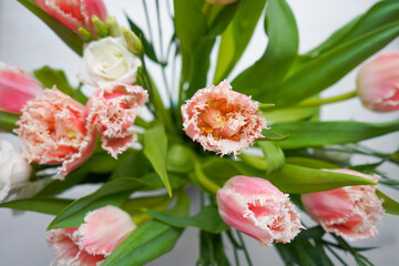 Top view of pink tulips bouquet with pink ribbon. International Women's Day.