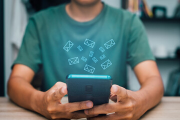 The man sitting checking email online on a smartphone device to looking  new letter in the room