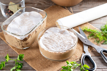 Frozen pate. Liver pate in a glass jar on a table.