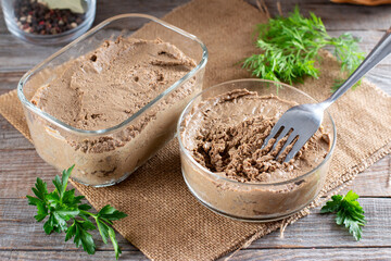 Liver pate in a glass jar on a table