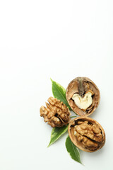 Walnuts with nutshell and leaves on white background