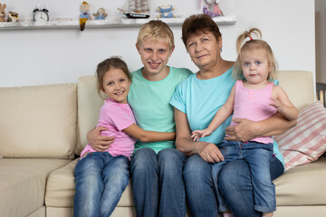 Grandmother sits with grandchildren