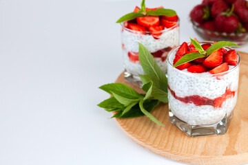 Delicious and healthy dessert with fresh strawberry, yogurt, chia seeds and fresh mint. Healthy breakfast concept. ?lose-up. Copy space.